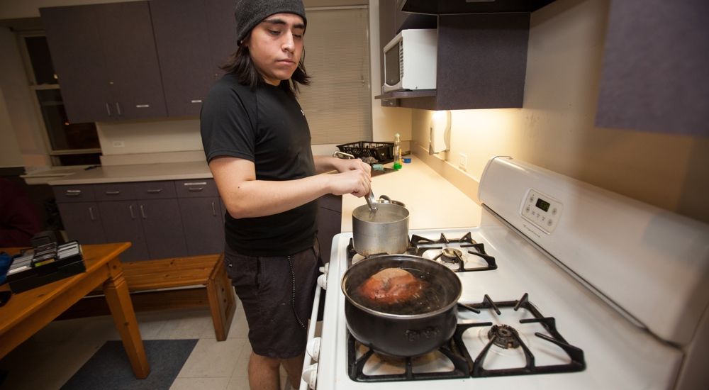 A client of The Night Ministry prepares a meal for himself.